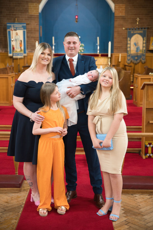 Mother and father with baby at christening